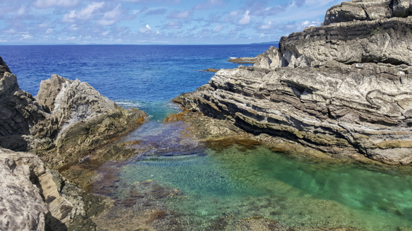 Sitting at the foot of Poseidon Rock, this small rock pool serves as the ideal chill spot when on the islet